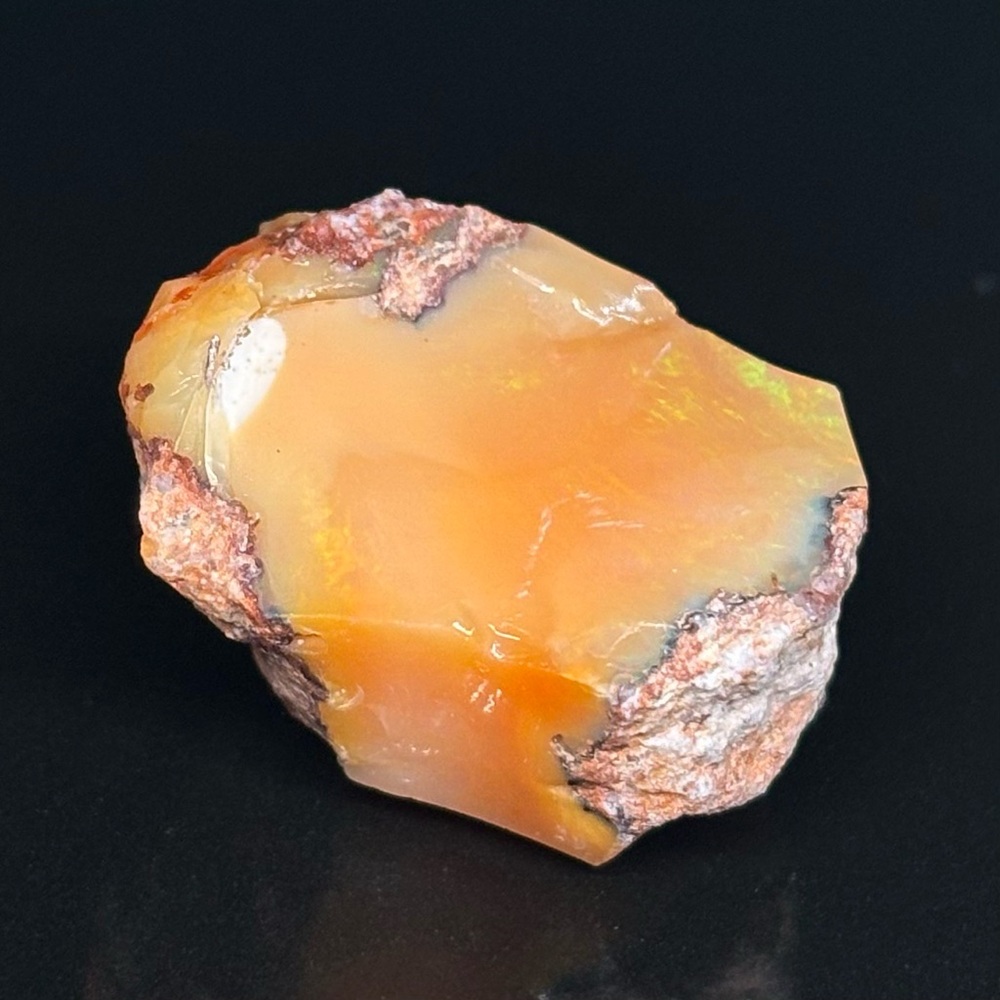 Mexican Fire Orange Punch Opal Stone Specimen Portraying A Beautiful Light Show